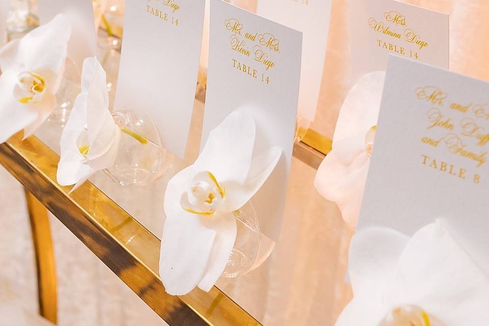 Place cards in floral vase