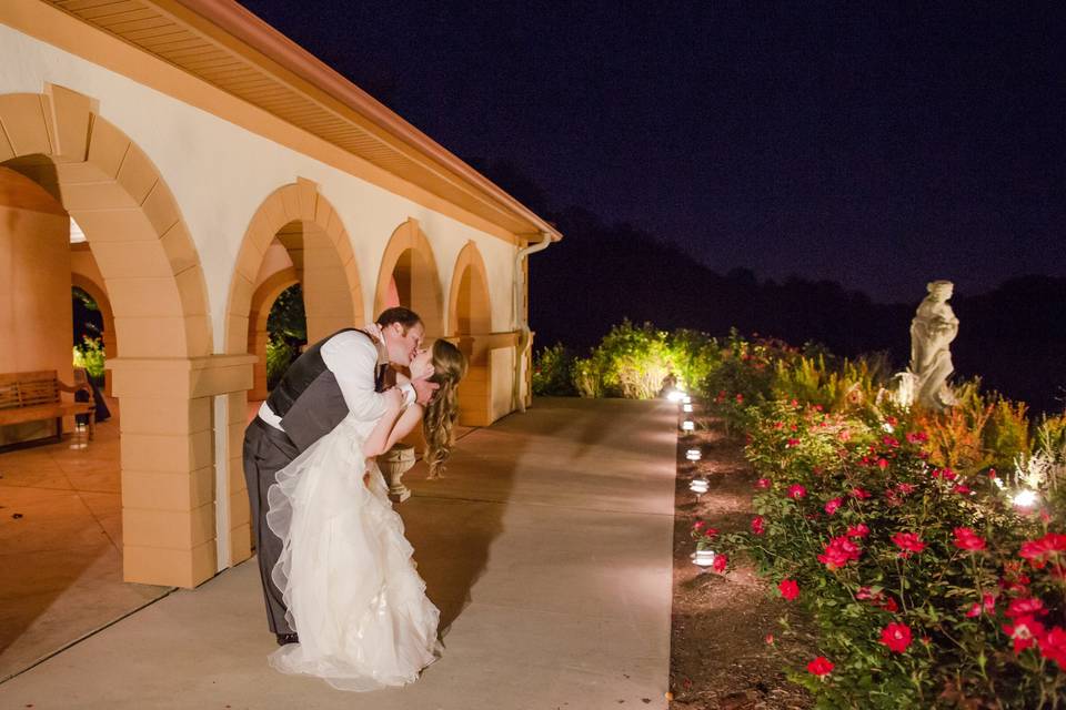 Groom dips his bride for a kiss