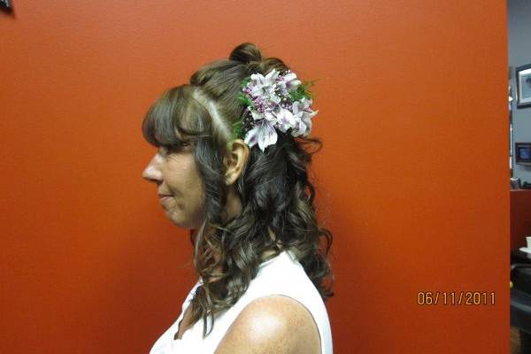 Mother of the Bride, Very young mama.  Bangs , pulled back with small bump, some pinned up back curls, hanging lose figure 8 curls and live lavender flowers to match her dress.