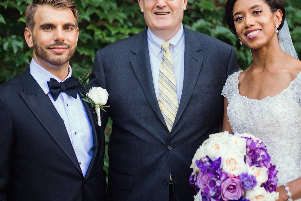 Posing with bride and groom