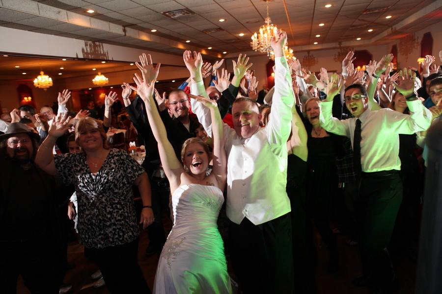 The couple with guests dancing