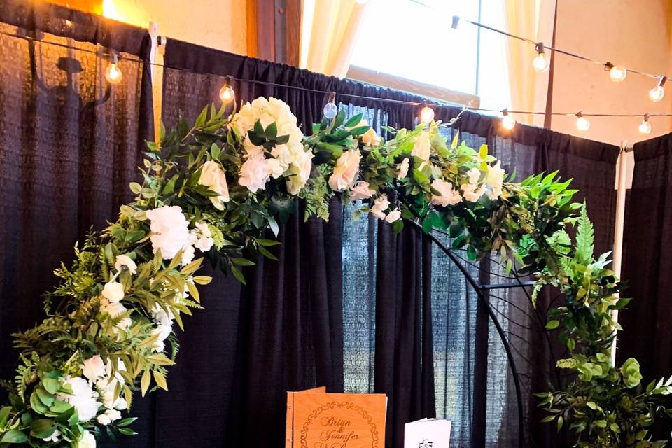 Floral arch and wine barrel