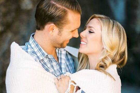 Bride and groom share a shawl