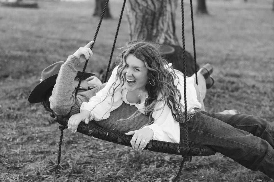 Couple laughing on swing