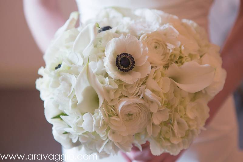 All white bouquet of hydrangea, anemone, ranunculus, calla lilies, and lisianthus