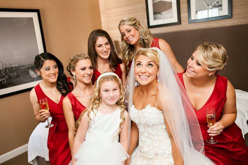 Bride, bridesmaids, and flower girl in the room