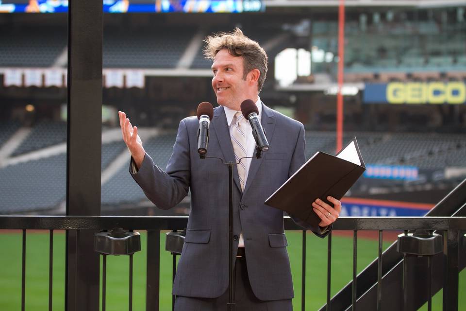 Yes, they do weddings at Citifield! What a great experience. The mic I used carried throughout the entire stadium. So fun. Thanks Britt & Kevin! This photo makes it look as if the wedding was sponsored by Geico. 15 minutes can save you 15% on car insurance. But then, you knew that.