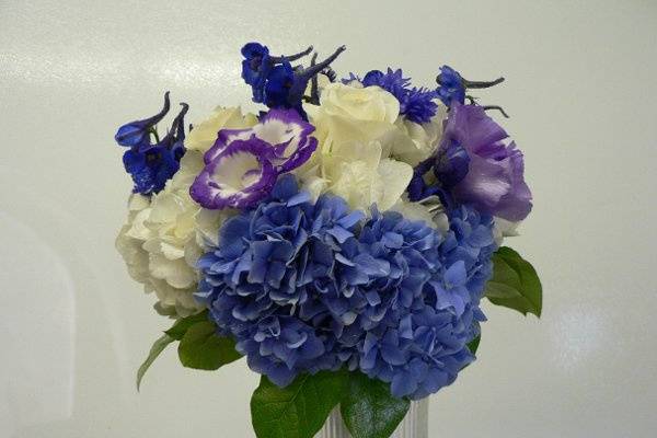 Handtied bouquet of blue and white hydrangias, purple two-tone lizzianthus and delphinium