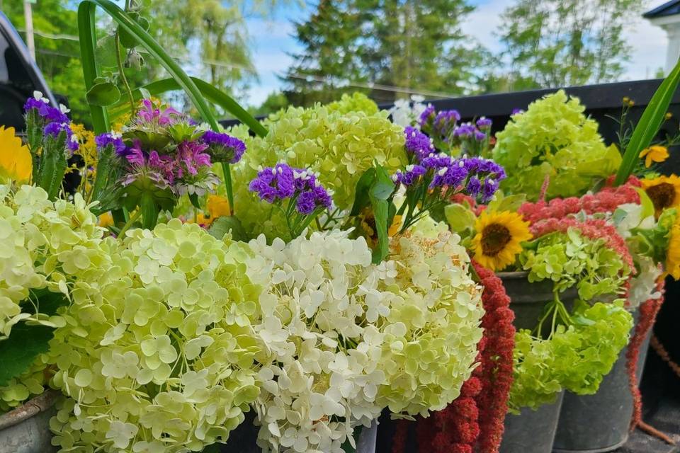 Rustic florals in sap buckets