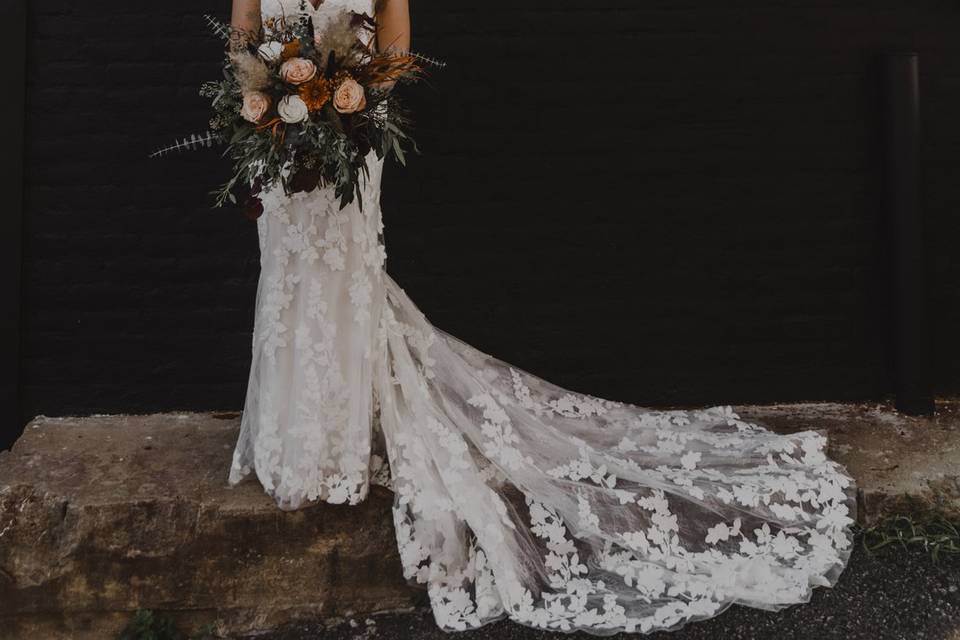 Bride In Front of Venue Wall