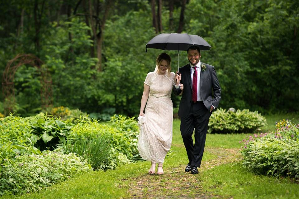 Newlyweds strolling in the rain