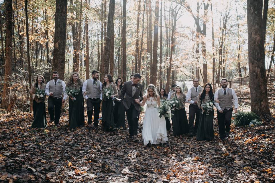 Wedding party posing in the woods