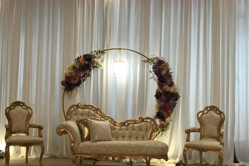 Gold furniture and floral arch