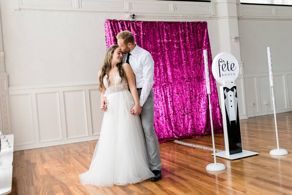 Photo booth with pink backdrop