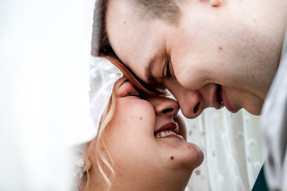 Couple embrace in veil
