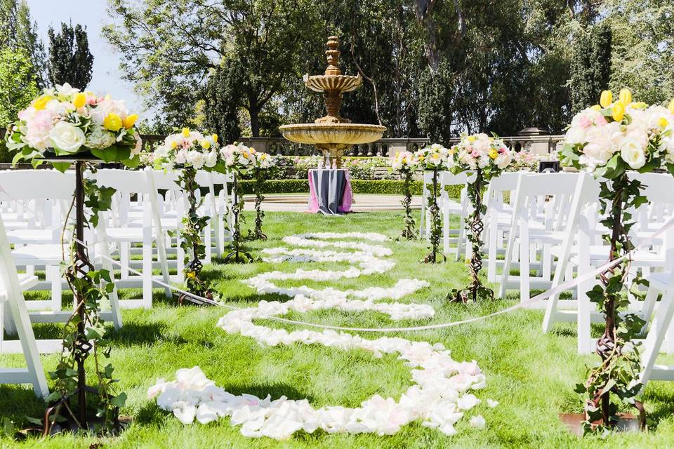 Ceremony Decor. Tall vine aisle floral arrangement and petal aisle runner. Sheena & Keith Beverly Hills Wedding Ceremony @Greystone Mansion (Gavin Farrington Photography)