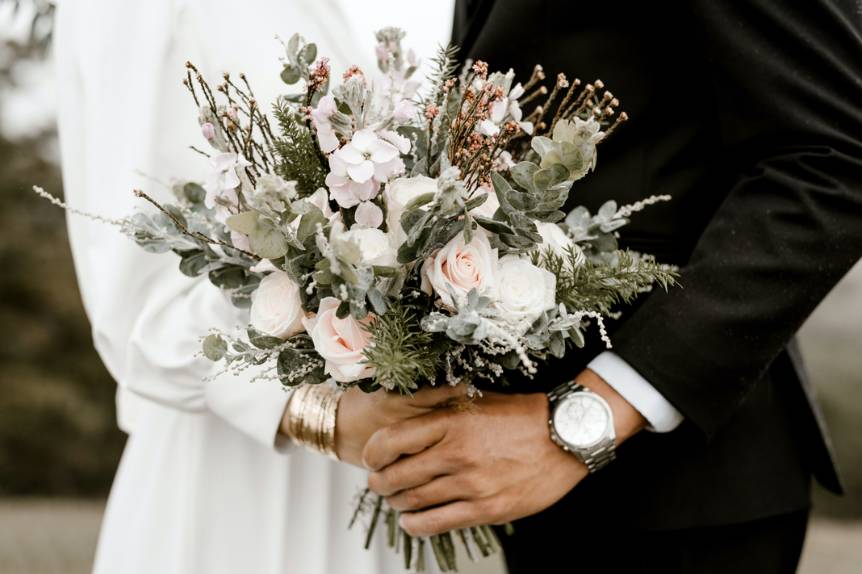 Couple with bouquet in hand