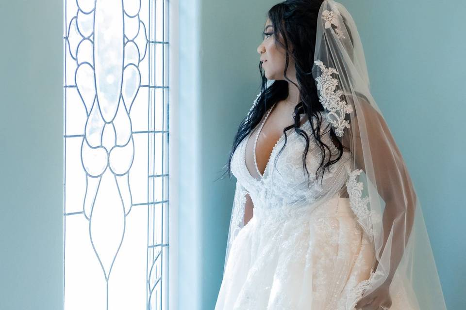 Bride looking out a window