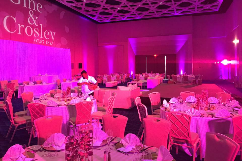 Custom monogram with pink uplighting and aerial lighting