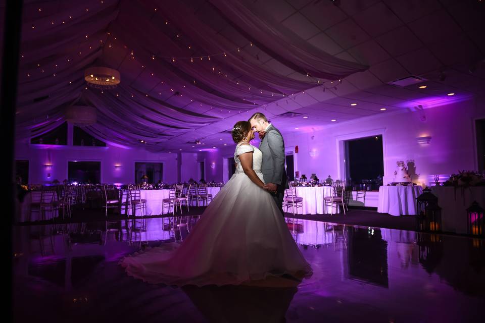 Illuminated DJ booth and two vertical towers and intelligent lighting