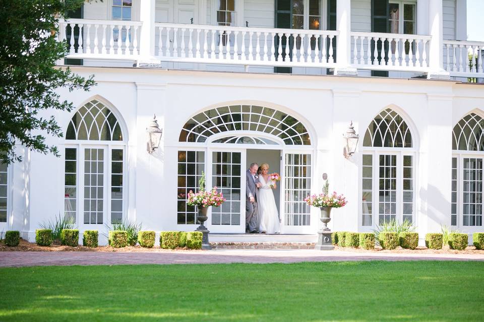 The Mr and Mrs on the grounds at Lowndes Grove. Live oaks and moss hanging from the trees made it the perfect site for this Lily Pulitzer meets Camo Man wedding!