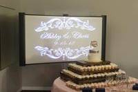 Projection behind wedding cake