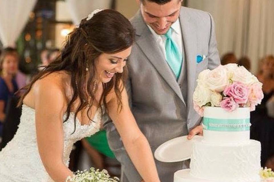 Bride and groom slicing cake