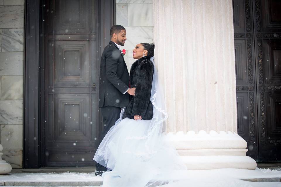 Groom and bride by the column