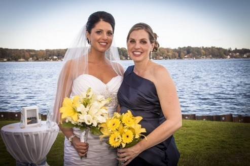 Bridal bouquet of lilies and calla lilies with wrapped stems and attendant bouquet of lilies and gerbera daisies by Loeffler's Flowers