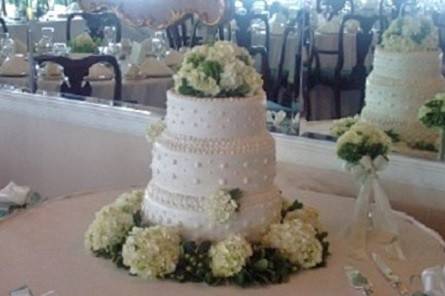 Cake flowers of white hydrangeas and greens by Loeffler's Flowers