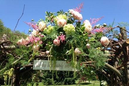 Ceremony - Back side of arbor with one floral piece by Loeffler's Flowers