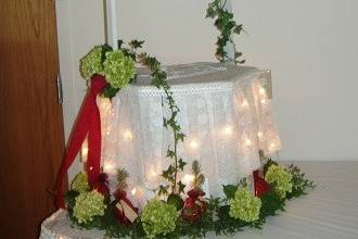 Reception flowers - wishing well card holder decorated with green hydrangeas and lights by Loeffler's Flowers