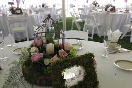 Reception floral with bird cage by Loeffler's Flowers