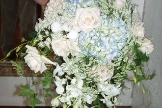 Bridal bouquet of hydrangeas, orchids and roses with ivy and greens by Loeffler's Flowers