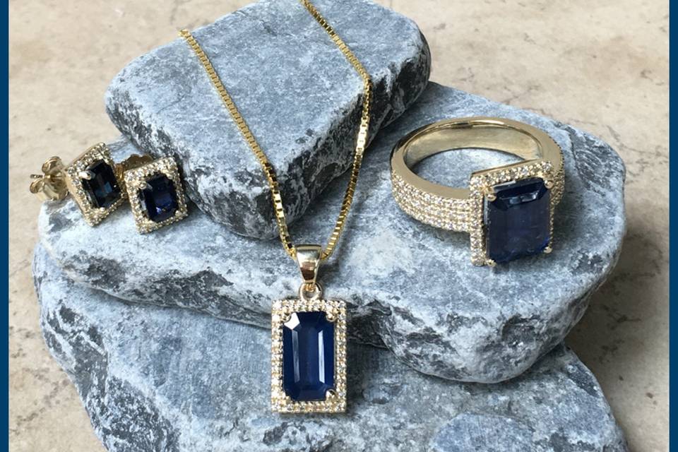 This gorgeous threesome includes earrings, a necklace, and an engagement ring, all with blue sapphires and diamonds!
See full details here:
- Earrings:
https://www.lauriesarahdesigns.com/product/blue-sapphire-earrings-rectangular-diamond-halo/
- Necklace:
https://www.lauriesarahdesigns.com/product/blue-sapphire-pendant-rectangular-diamond-halo/
- Engagement Ring:
https://www.lauriesarahdesigns.com/product/halo-engagement-ring-blue-sapphire-3-row-diamond-shank/
