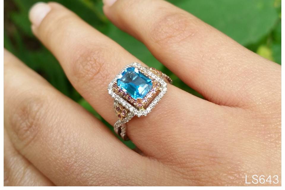 You'll never find a gem as blue as this one! This is our blue topaz December birthstone ring with a pink sapphire and double diamond halo!
See full details here:
https://www.lauriesarahdesigns.com/product/blue-topaz-ring-pink-sapphire-diamond-double-halo/