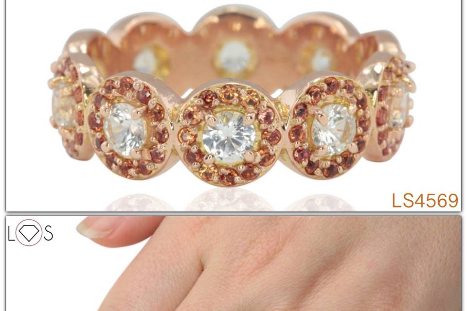 If you like sapphires, then this is the ring for you! It is made with dazzling white and peach sapphires, and set in a beautiful rose gold.
See full details here:
https://www.lauriesarahdesigns.com/product/eternity-ring-white-peach-sapphire-halo-ring-rose-gold/