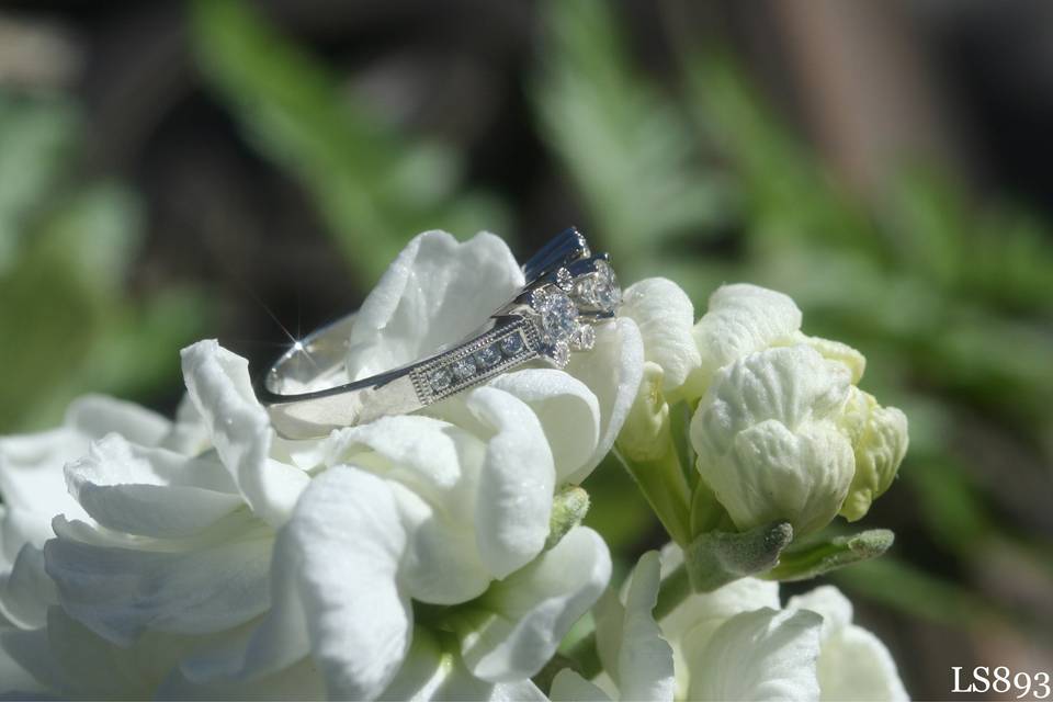 Nestled in the snapdragons is a beautiful engagement ring with diamond flowers!