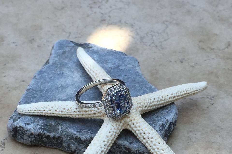A dazzling blue sapphire engagement ring with a double halo of diamonds!