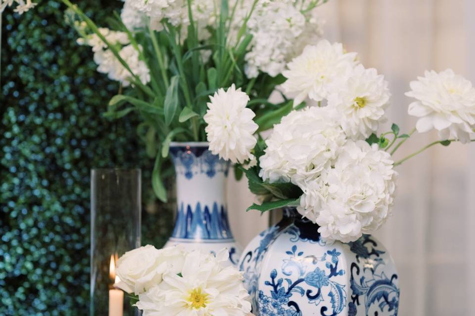 White flowers in blue vases