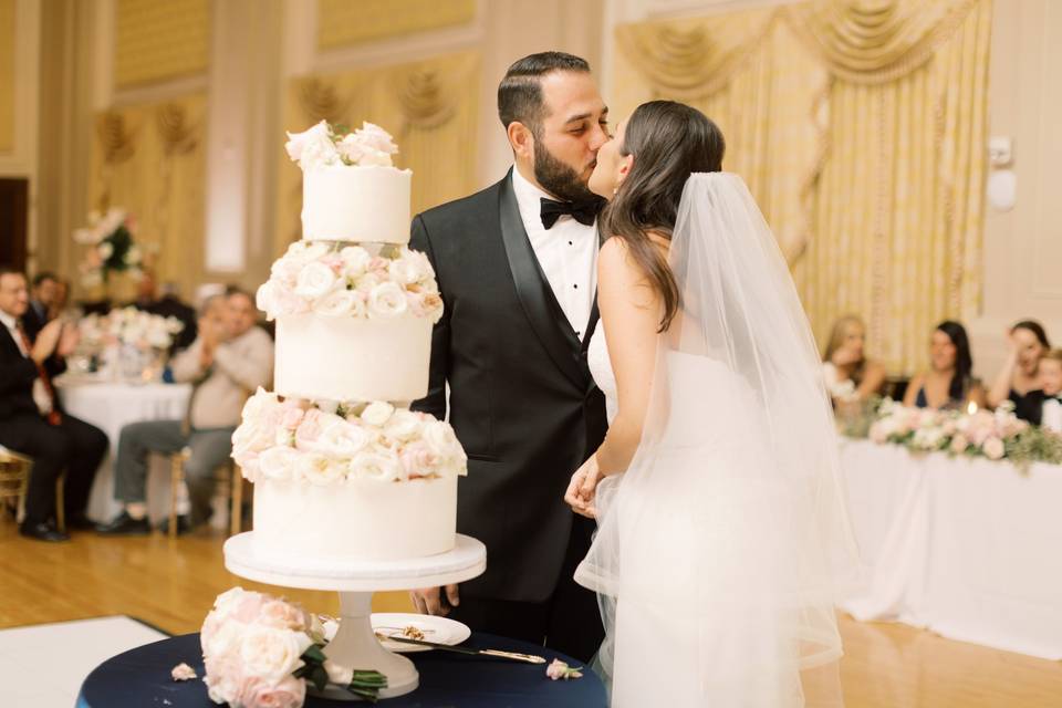 Couple kissing by cake