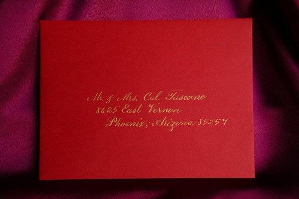 Gold lettering on a red envelope.  The style of calligraphy is a very traditional tyle.