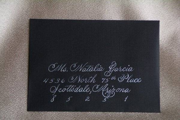 A response card envelope drawn in white ink on a black envelope