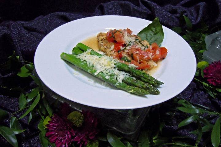 Basil chicken: sautéed breast of chicken with roma tomatoes, fresh basil & garlic in a white wine butter sauce & asparagus spears with lemon butter & parmesan cheese (seasonal)