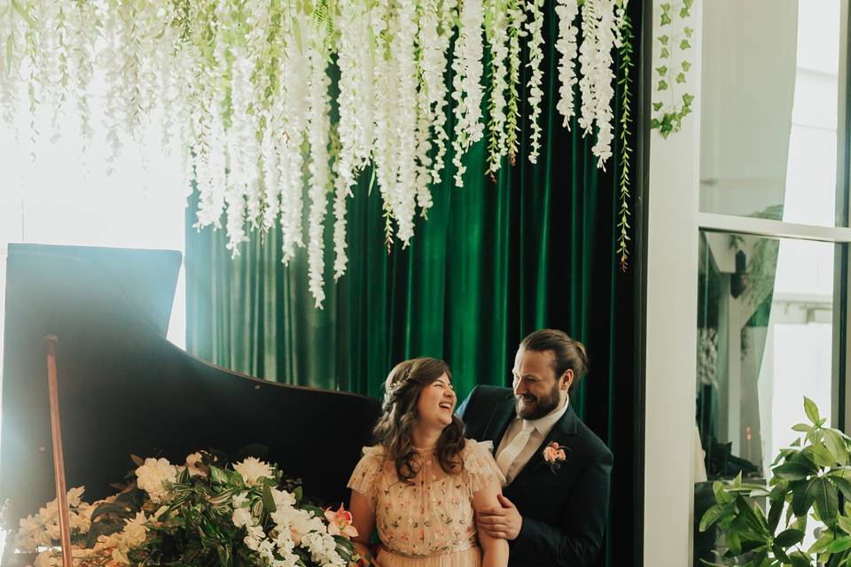 Couple posing by piano