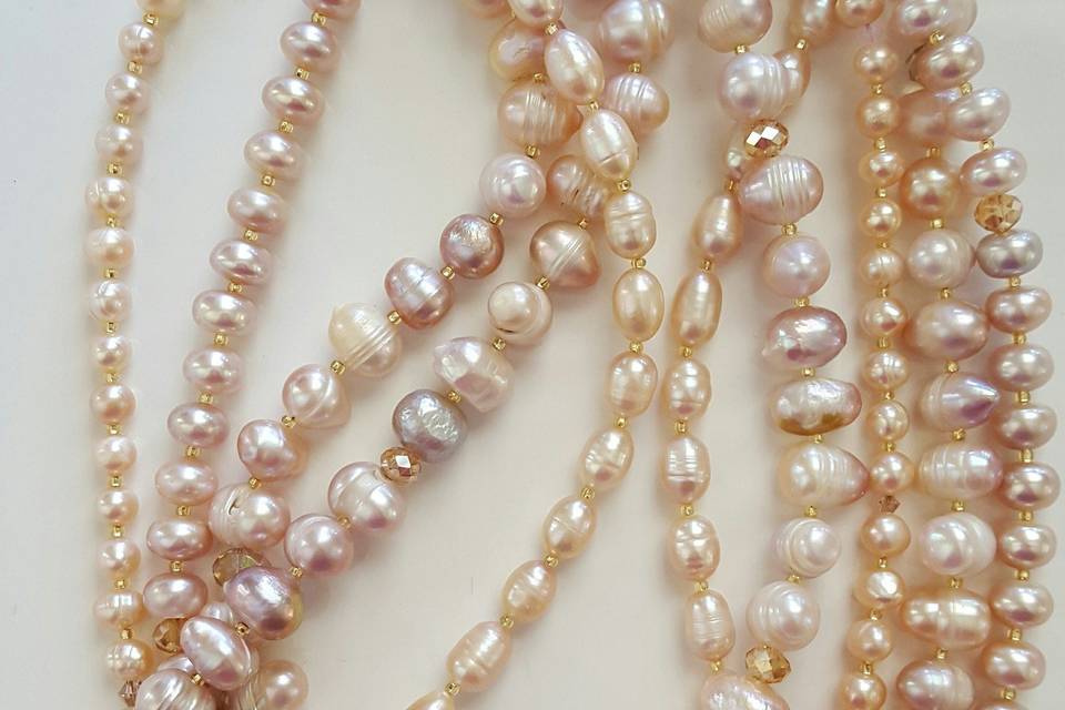 Marinella signature layered freshwater pearl necklace on a beautiful Rose Quartz color with gold and champagne Swarovski crystals. Large reproduction brass clasp. Wear beyond your gown!