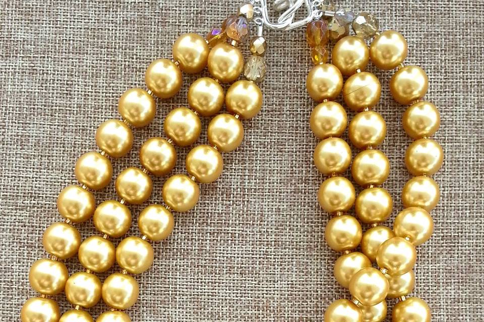 Marinella jewelry signature layered necklace. Gold Swarovski crystal pearls with silver-tone clasp. Triple layered. Wear beyond your gown!