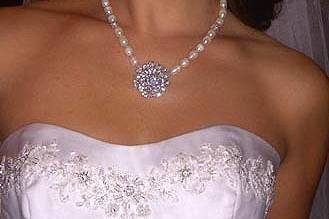 Real bride wearing a freshwater pearl necklace with a stunning Swarovski crystal center focal point embellishment. Wear beyond your gown!