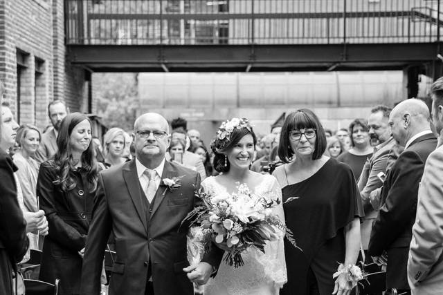 Parents walking with the nearly wed down the aisle