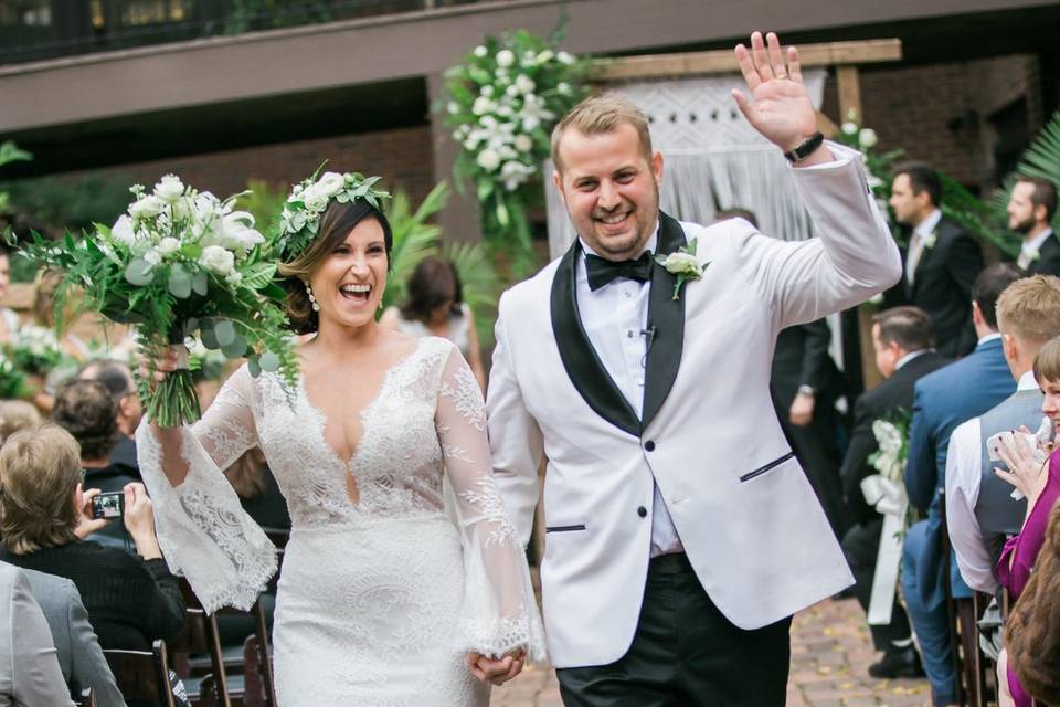 Couple walking happily down the aisle